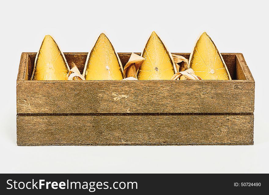 Gift set of 4 decorative candles in the form of lime segments in a wooden box on a white background. Gift set of 4 decorative candles in the form of lime segments in a wooden box on a white background.