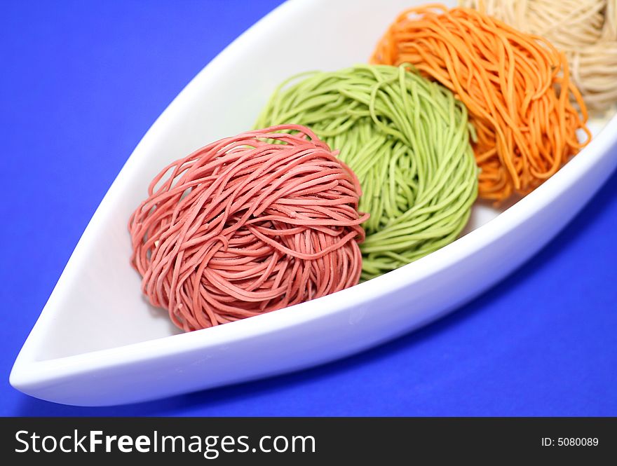 Some colourful chinese vegetables noodles in lovely table-ware