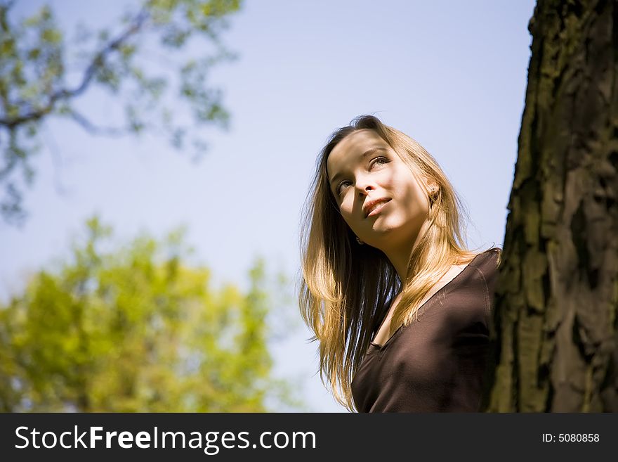 Blond Woman Relaxing In The Forest