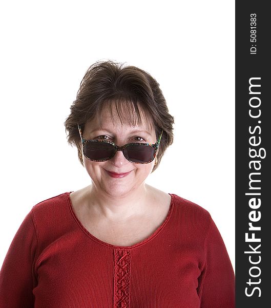 An attractive middle aged woman looking over her sunglasses. An attractive middle aged woman looking over her sunglasses