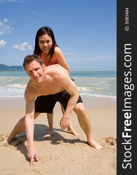 A multiethnic couple enjoying the tropical at the beach. A multiethnic couple enjoying the tropical at the beach