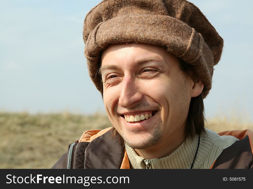 Portrait of happy man in hat on background of nature. Portrait of happy man in hat on background of nature