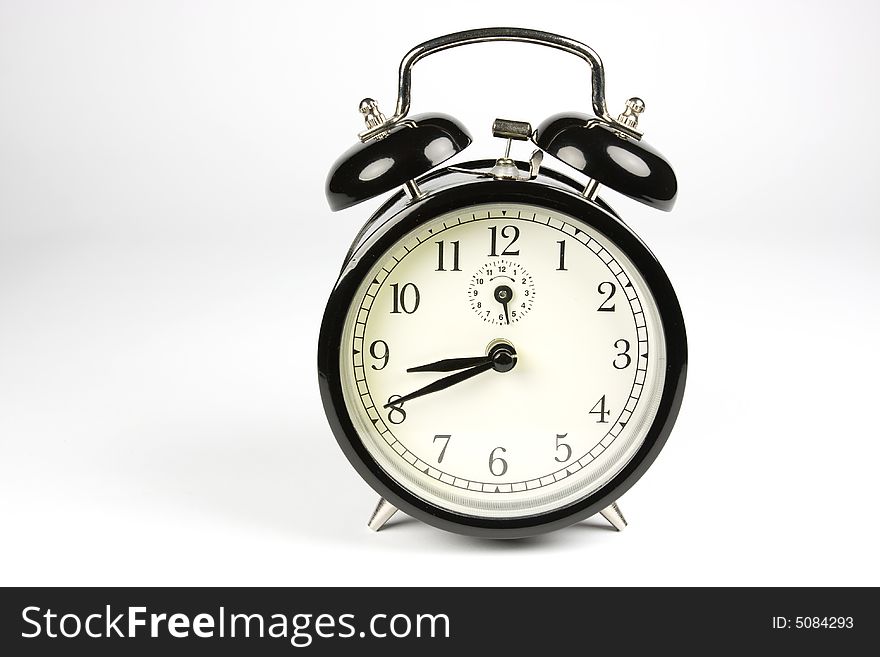 Traditional black alarm clock on white background. Traditional black alarm clock on white background