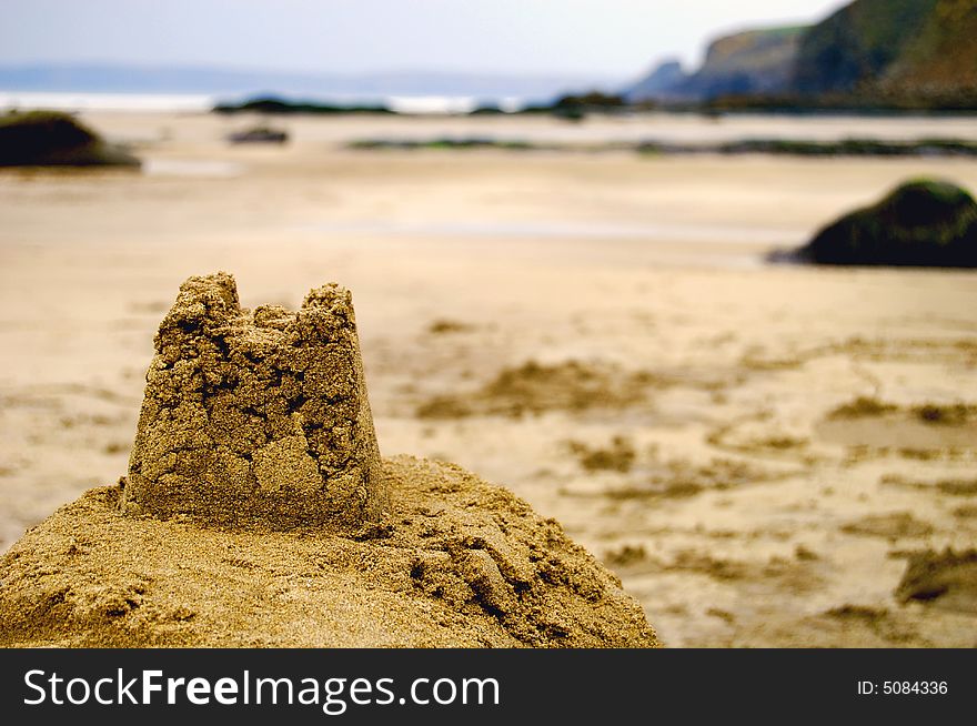 Broken sandcastle on a deserted beach