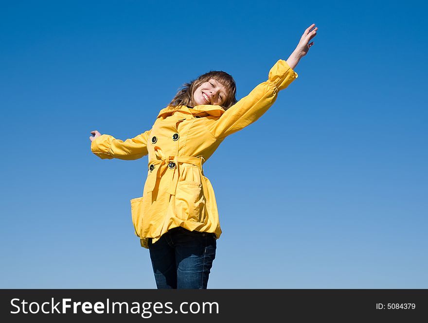 Happy female teenager on the sky background with room for text. Happy female teenager on the sky background with room for text