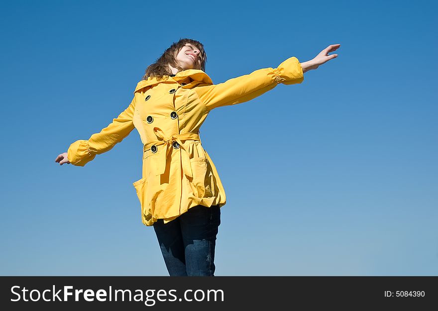 Happy female teenager on the sky background with room for text. Happy female teenager on the sky background with room for text