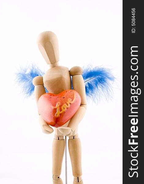 Symbol of love, manikin giving a heart