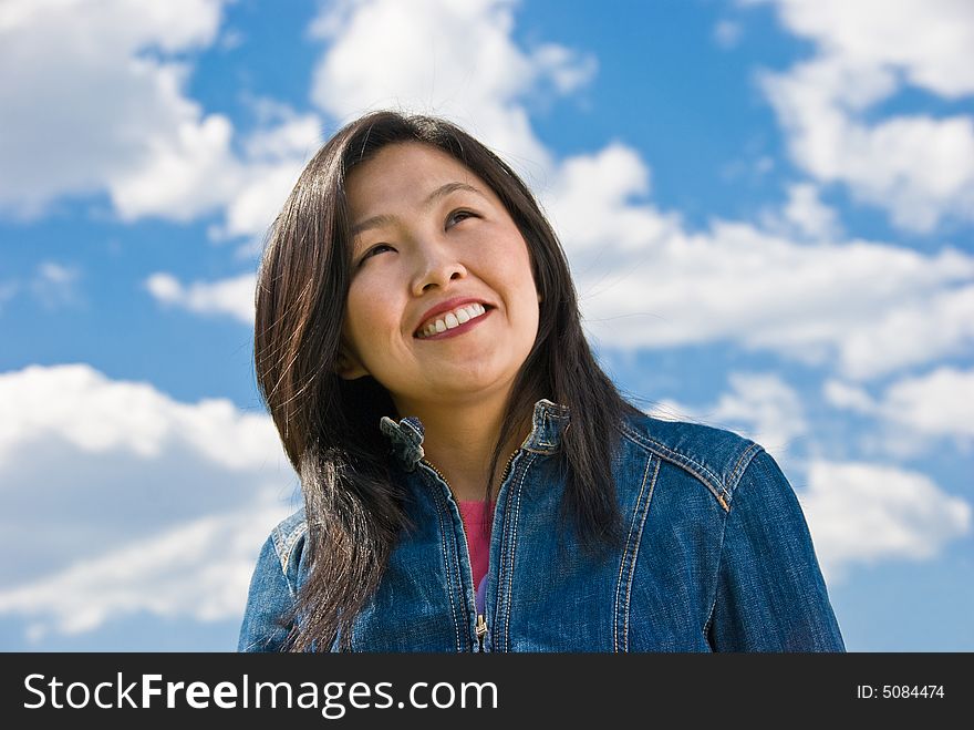 Attractive young woman portrait over sky background with room for text. Attractive young woman portrait over sky background with room for text