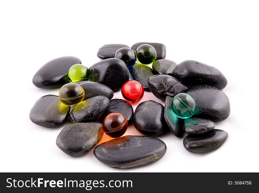 Bath balls on the black stones background