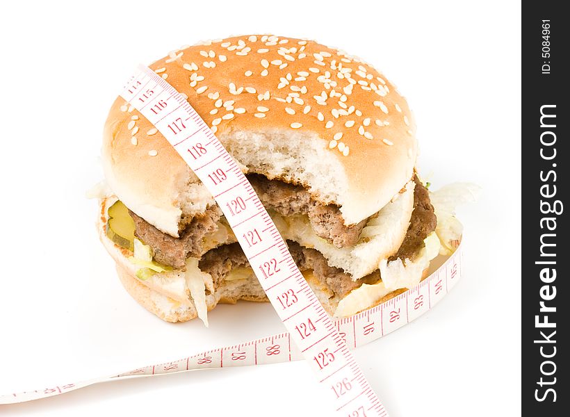 Bread with fried meat, cheese, onion, lettuce and measuring tape isolated on a  white background. Bread with fried meat, cheese, onion, lettuce and measuring tape isolated on a  white background.