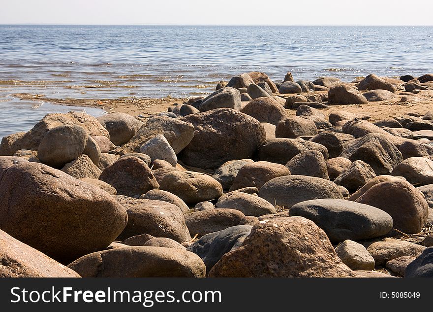 Stones on a background of the  blue sea. Stones on a background of the  blue sea
