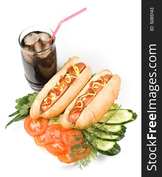 Hot dogs with vegetables and a glass of cola with ice isolated on a white background