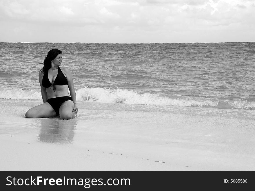 Beautiful, brunette swimsuit model in classic black and white posing on the white sands of the Caribbean. Beautiful, brunette swimsuit model in classic black and white posing on the white sands of the Caribbean.