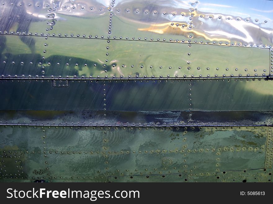 Reflection at an old ariplane with blue sky