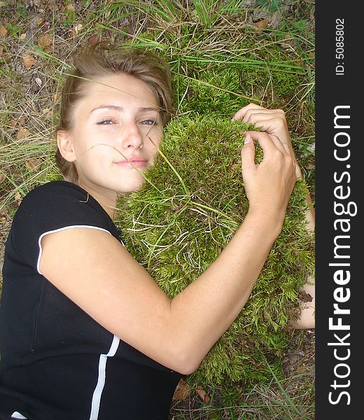 Girl lays embraces a moss. Girl lays embraces a moss