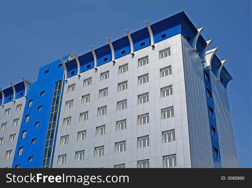 New multistoried building on a background blue sky, social habitation