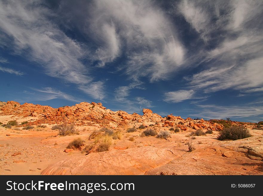 View of the red rock formations in San Rafael Swell with blue skyï¿½s and clouds. View of the red rock formations in San Rafael Swell with blue skyï¿½s and clouds