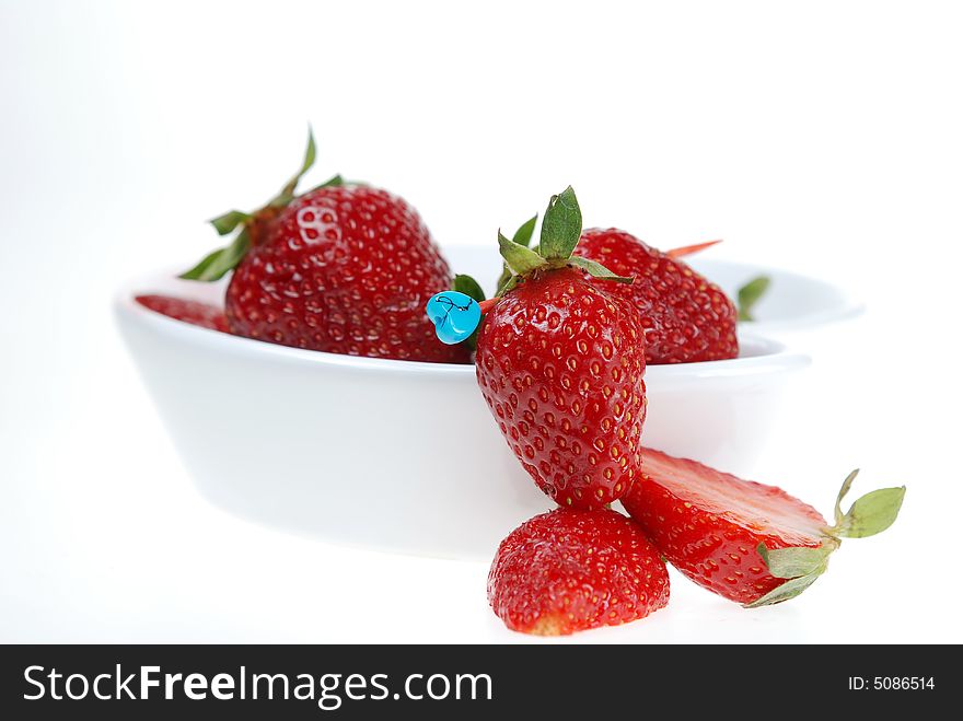 Strawberry in and out of white ceramic bowl