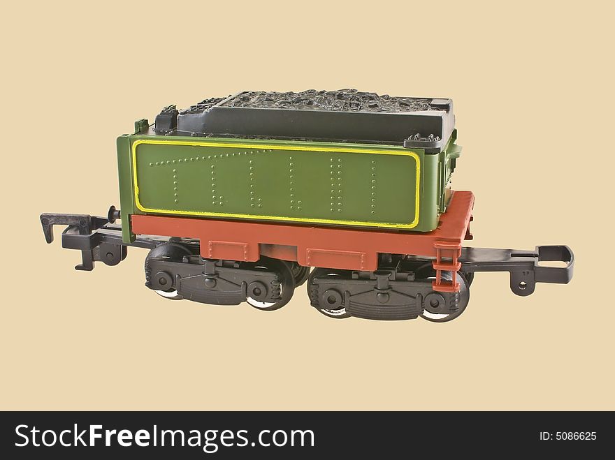 Model train coal car isolated on beige background.