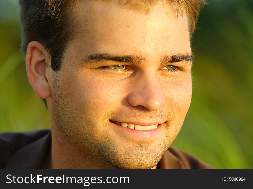 White male smiling and looking at the camera. Blurry background. White male smiling and looking at the camera. Blurry background.