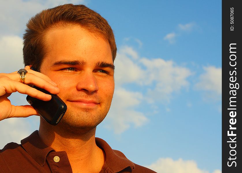 Image of a handsome young man on the phone. Image of a handsome young man on the phone