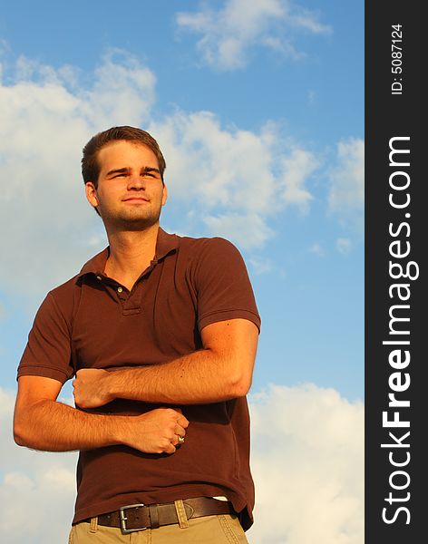 Caucasian man flexing his muscles with sky background. Caucasian man flexing his muscles with sky background.