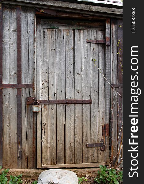 Closed wooden door of old shed