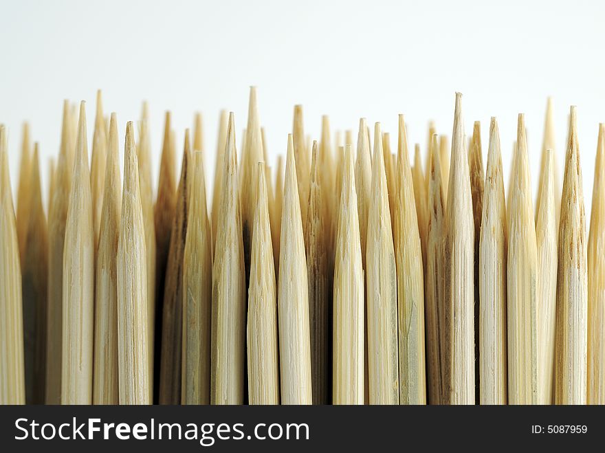 Sharpened bamboo skewers against white background