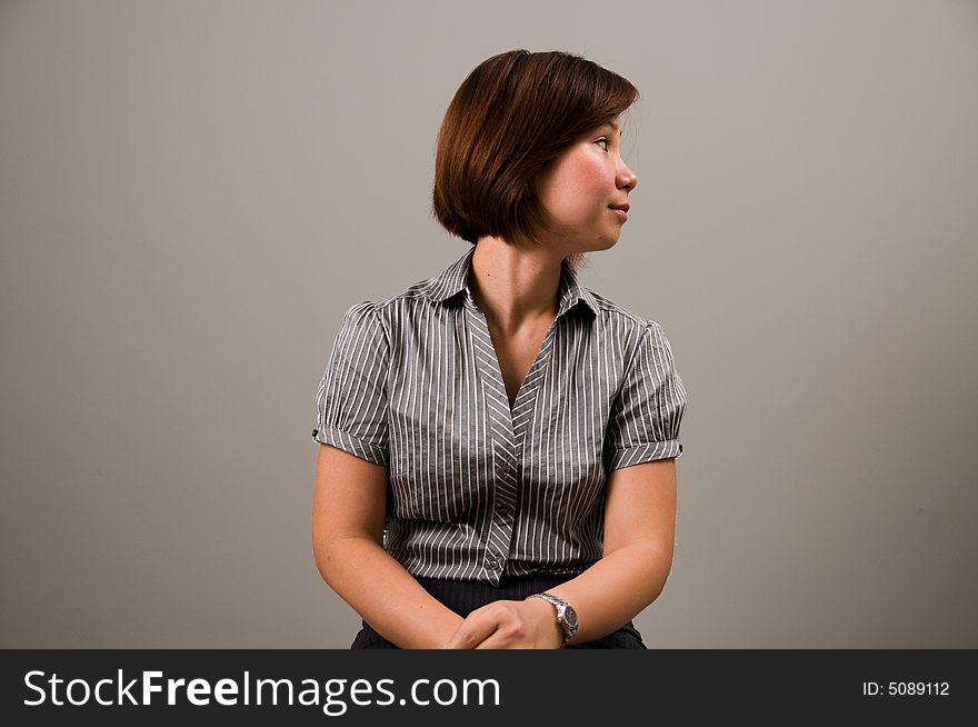 Asian lady in business attire, looking to the right