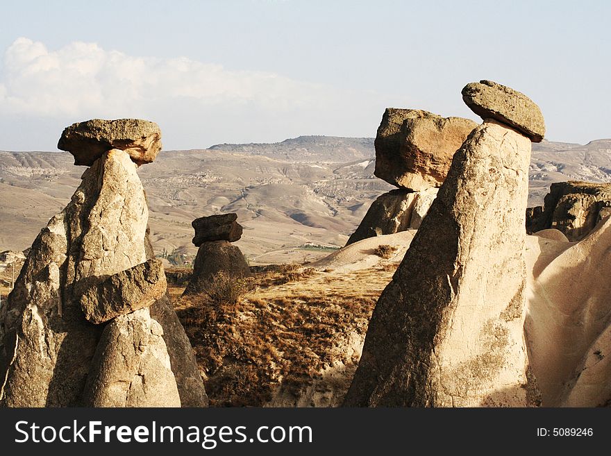 rocks perched on top of geological formation in cappadocia. turkey. rocks perched on top of geological formation in cappadocia. turkey