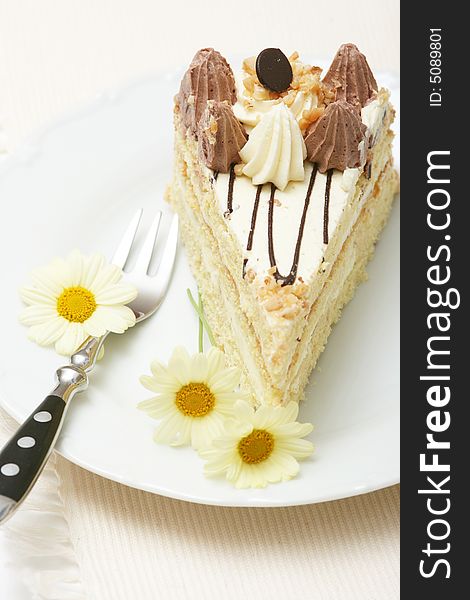 A slice of a cream cake with spring flowers. A slice of a cream cake with spring flowers.