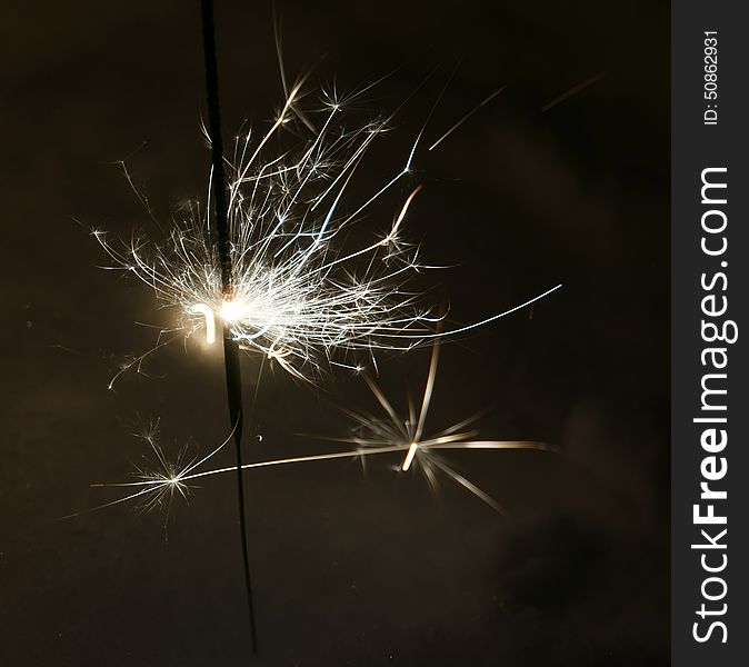 Bright christmas sparkler, bengal fire burning in the night.