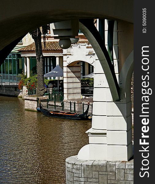 Arch of a bridge framing a moored gondola at a shopping mall in Cape Town. Arch of a bridge framing a moored gondola at a shopping mall in Cape Town.