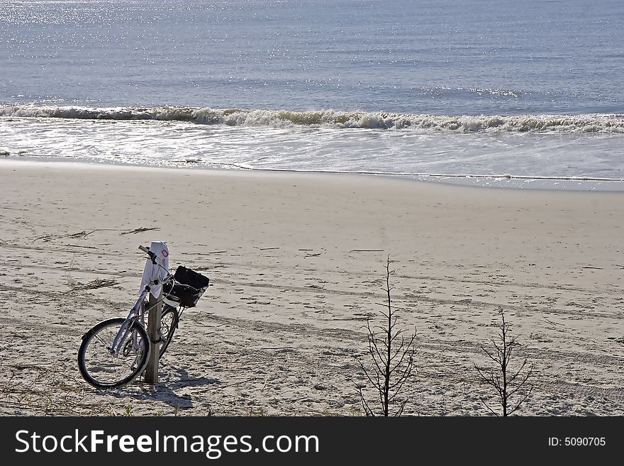 A lone bicycle on an empty stretch of beach. A lone bicycle on an empty stretch of beach