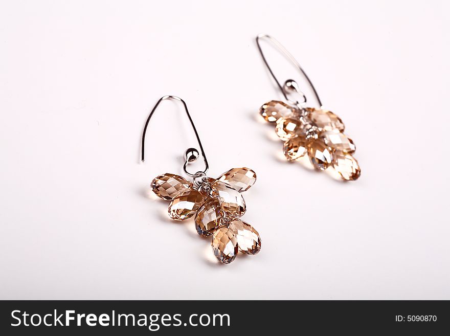 A pair of earrings on white background