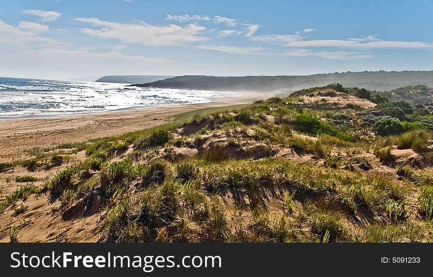 Seascape with sand dunes and surf
