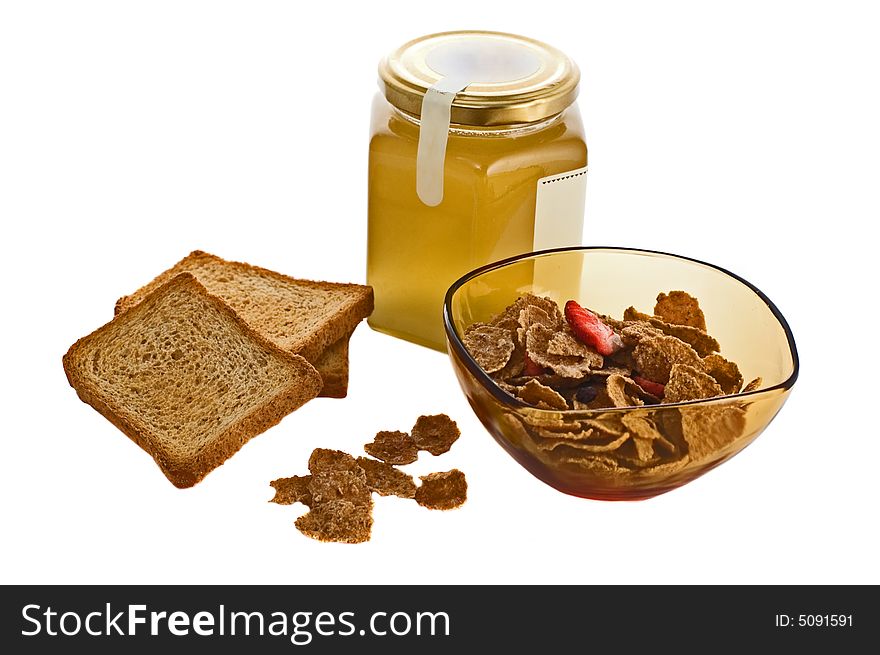 Bowl of cereals with honey jar and toasted bread isolated on white. Bowl of cereals with honey jar and toasted bread isolated on white