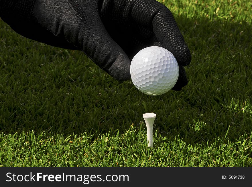 Ball,hand and tee