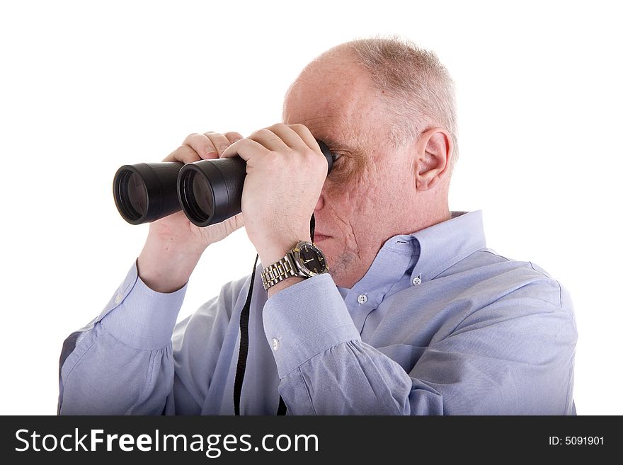 An older guy in a blue shirt looking to the right through binoculars. An older guy in a blue shirt looking to the right through binoculars