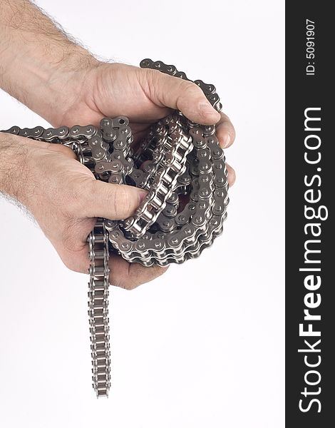 Hands with metal link chain on a white