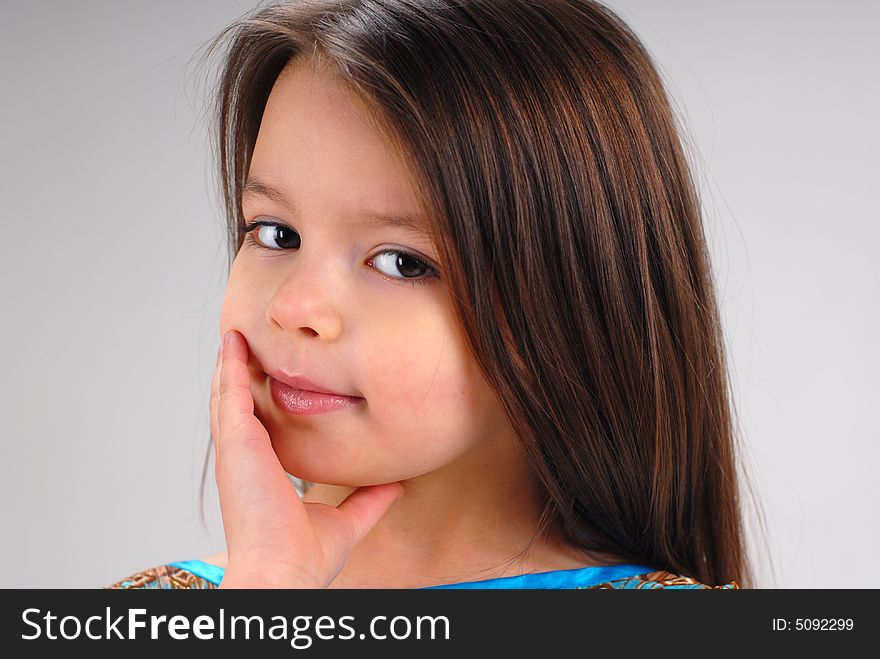 Portrait of a cute little girl with long brown hair. Portrait of a cute little girl with long brown hair