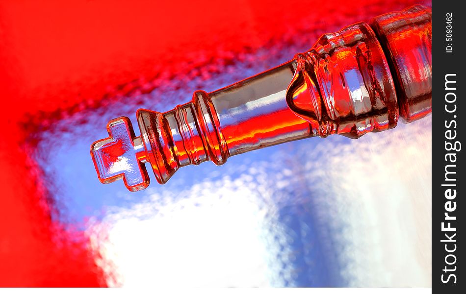 Close-up of glass chess king against multi colored abstract background. Close-up of glass chess king against multi colored abstract background