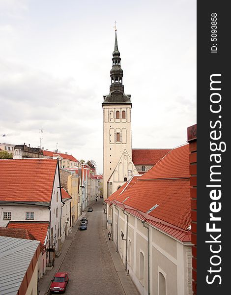 Street of old city Tallinn with church and roofs