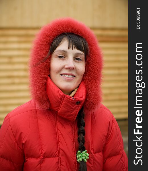 Cute Winter Girl and Wooden Wall on Background