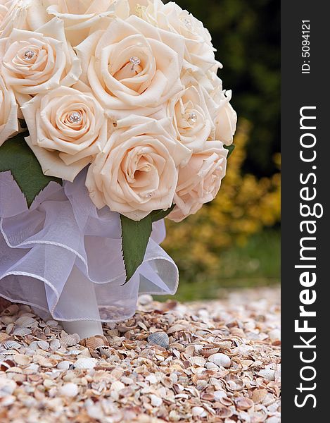 Bridal cream roses bouquet over seashells