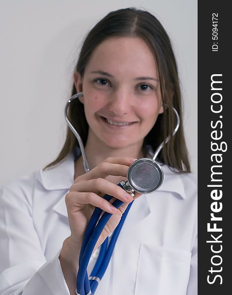 An isolated shot of a medical intern smiling and holding a stethoscope. An isolated shot of a medical intern smiling and holding a stethoscope.