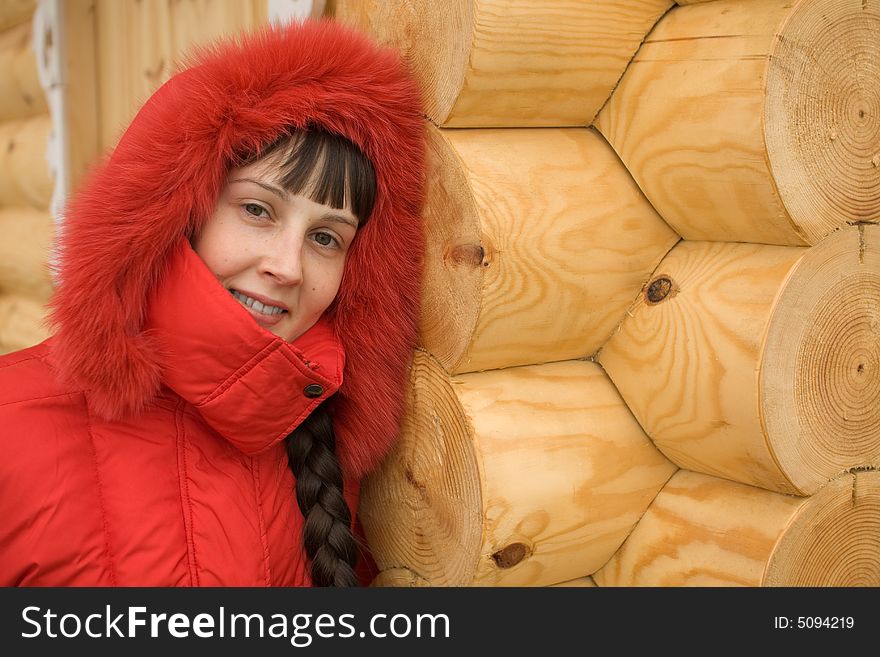 Cute Winter Girl and Wooden Wall on Background