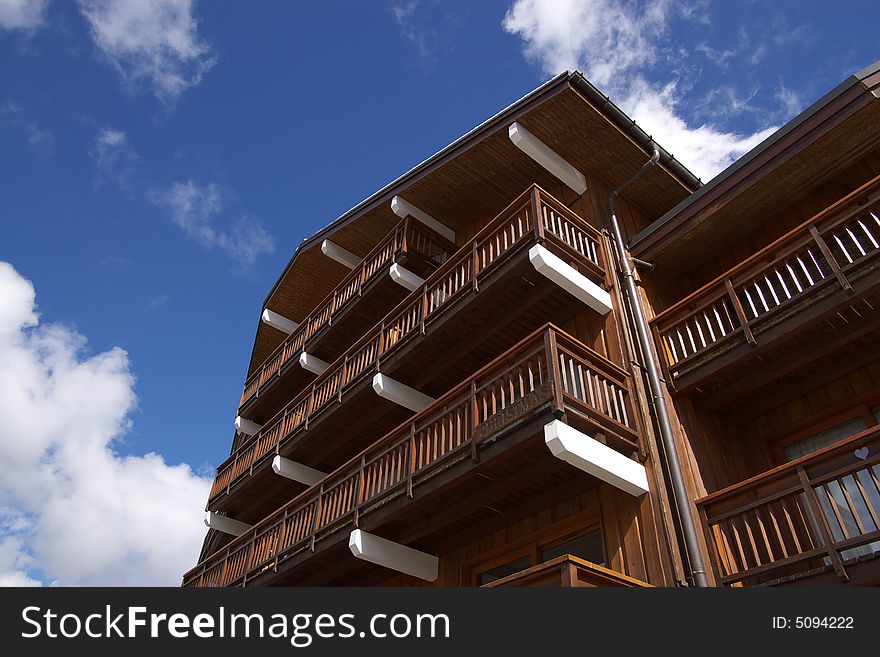 Traditional swiss wooden house with balconies , view from down to top. Traditional swiss wooden house with balconies , view from down to top.