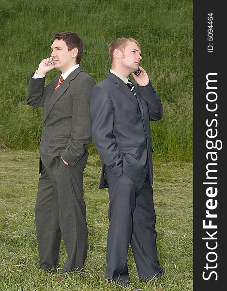 Businessmen talking by phone outdoor