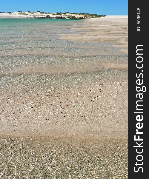 Deep ripples in the sand are filled with water It is low tide at the mouth of a creek in the Kimberlie region of North-West Australia. Deep ripples in the sand are filled with water It is low tide at the mouth of a creek in the Kimberlie region of North-West Australia.